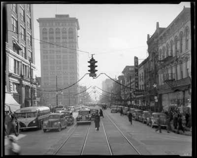 Dupont; Main Street, Christmas scenes (decorations); view looking                             down length of Main Street; police officer standing in the middle of the                             road