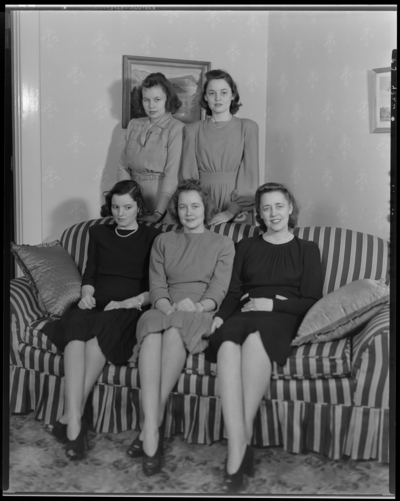 Mrs. Middletown; five women (girls) gathered around a couch                             (sofa); group portrait