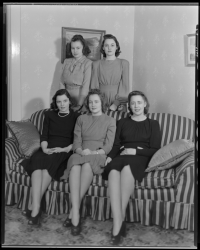 Mrs. Middletown; five women (girls) gathered around a couch                             (sofa); group portrait
