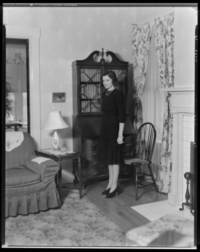 Mrs. Middletown; woman (girl) standing next to a                             chair