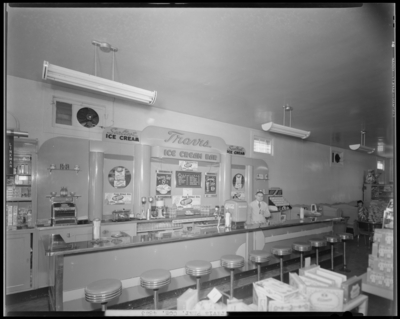 Travis Phar; Soda Fountain, 848 East High; interior view of ice                             cream bar, man standing behind the counter; photograph ordered by                             Sealtest Ice Cream Company