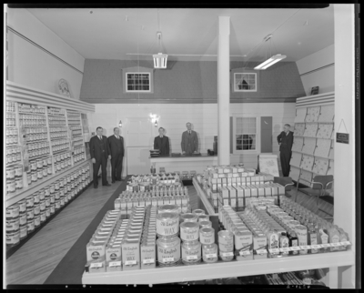 R.F. Johnston Paint & Glass Company, 310-312 West Short;                             interior view of store and products, five men standing behind the                             counter and next to the product lines