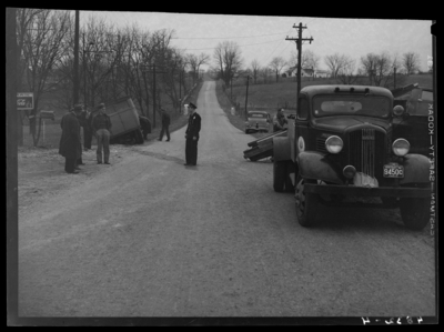 State Auto Mutual Insurance Company: wreck of Fayette                             African-American segregated school bus and truck; view looking down                             road, school bus in ditch, tow truck hoisting truck; police officer                             standing in the middle of the road, people are standing on the                             shoulder