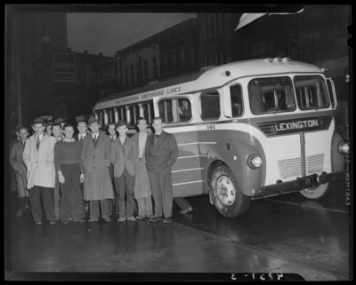 Southeastern Greyhound Lines (bus); group of men standing next to                             a bus parked by the curb