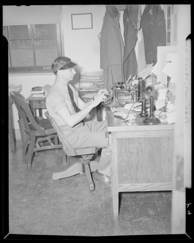 Kentuckian Staff & Press Room, (1942 Kentuckian)                             (University of Kentucky); McVey Hall, basement; man typing at a                             desk