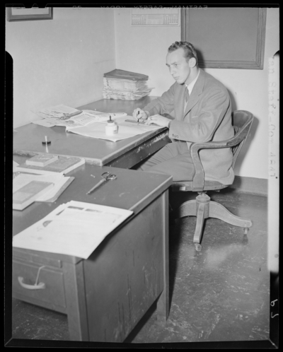 Kentuckian Staff & Press Room, (1942 Kentuckian)                             (University of Kentucky); McVey Hall, basement; man working at a                             desk