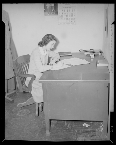 Kentuckian Staff & Press Room, (1942 Kentuckian)                             (University of Kentucky); McVey Hall, basement; woman working at a                             desk