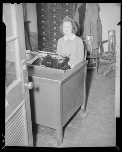 Kentuckian Staff & Press Room, (1942 Kentuckian)                             (University of Kentucky); McVey Hall, basement; woman typing at a                             desk