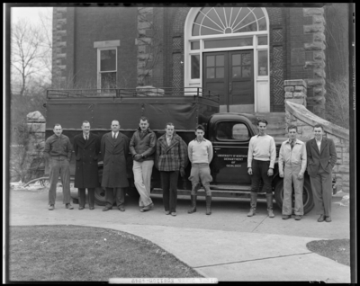 Sigma Gamma Epsilon, (1942 Kentuckian) (University of Kentucky);                             University of Kentucky Dept. (Department) of Geology truck parked in                             front of unidentified building, members standing beside                             truck