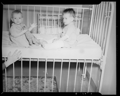 Kentucky Crippled Children’s Commission, Good Samaritan Hospital;                             two babies sitting in a crib