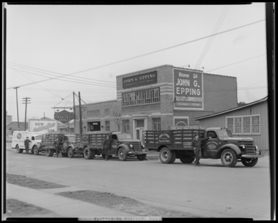 John G. Epping Bottling Works, 264 Walton Avenue; exterior, four                             company trucks parked in front of building, drivers standing next to                             their trucks