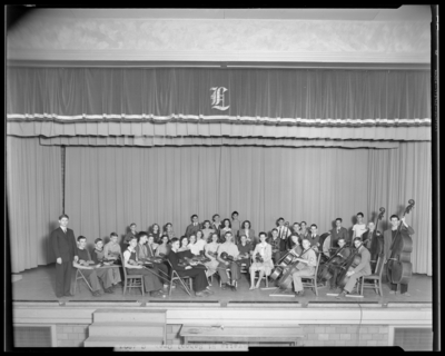 Orchestra, Lafayette High School; interior, orchestra members on                             stage; photographs requested by Dr. Crawford (Principal)
