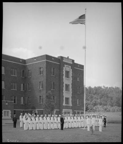 Moorhead College; exterior of unidentified building; naval                             officers standing next to a group of naval recruits (navy)