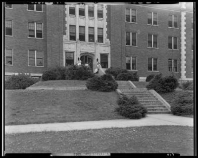 Moorhead College; Fields Hall; building, exterior; group of                             students gathered around the building's entranceway