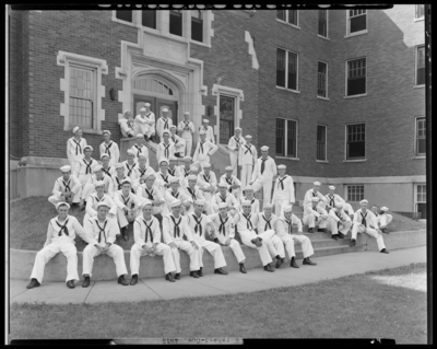Moorhead College; Thompson Hall; building, exterior; group of                             naval (navy) recruits in uniform gathered in front of building; group                             portrait