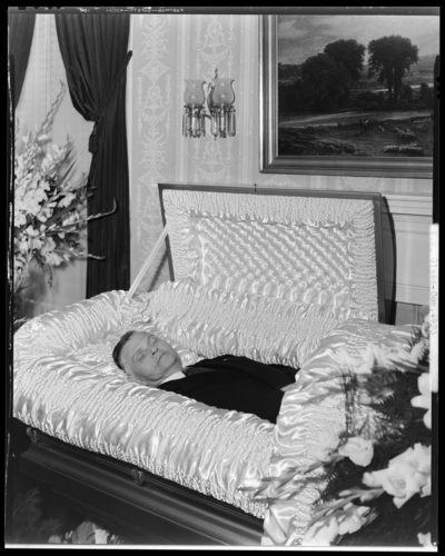 E.M. Glass; corpse, open casket