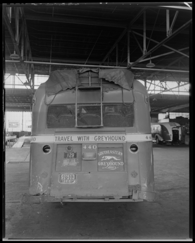 Southeastern Greyhound Lines (bus); wrecked (damaged) bus parked                             inside a service garage (repair); bus number 440 (no. 440); rear                             view