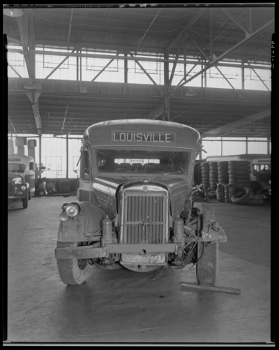 Southeastern Greyhound Lines (bus); wrecked (damaged) bus parked                             inside a service garage (repair); bus number 440 (no. 440); front view;                             destination sign reads 