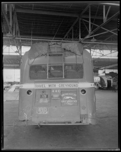 Southeastern Greyhound Lines (bus); wrecked (damaged) bus parked                             inside a service garage (repair); bus number 440 (no. 440); rear                             view