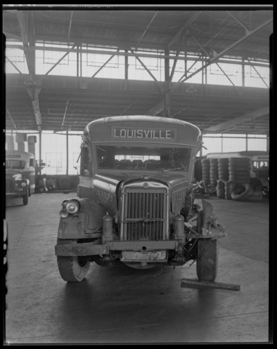 Southeastern Greyhound Lines (bus); wrecked (damaged) bus parked                             inside a service garage (repair); bus number 440 (no. 440); front view;                             destination sign reads 