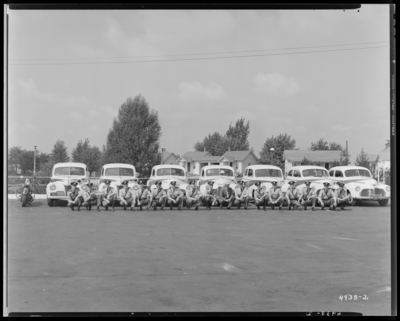 Kentucky State Highway Patrol, (1942 Kentuckian) (University of                             Kentucky); group of patrolman (police officers) squatting in front of a                             row of police cars