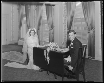 Mr. & Mrs. Jay Richard Miller Jr.; wedding; bride and                             groom sitting at table
