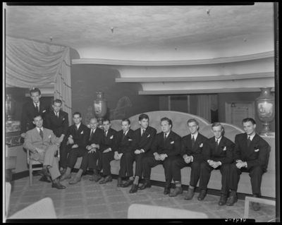 Bill Cross; orchestra; interior of unidentified building;                             orchestra members sitting on a couch (sofa)