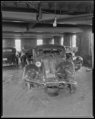 O.K. Service Garage (575 West Main); two wrecked (damaged) cars;                             photographs requested by John L. Davis; garage, interior; wrecked                             (damaged) car, front view; 1942 Ohio license plate number 458CZ (no.                             458CZ)
