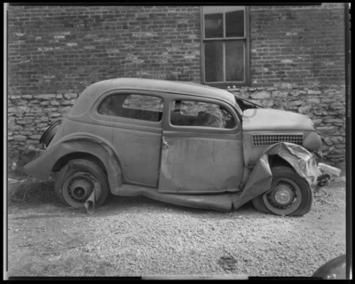 O.K. Service Garage (575 West Main); two wrecked (damaged) cars;                             photographs requested by John L. Davis; garage, exterior, wrecked                             (damaged) car, passenger's side view