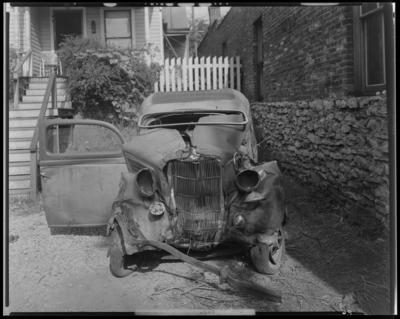 O.K. Service Garage (575 West Main); two wrecked (damaged) cars;                             photographs requested by John L. Davis; garage, exterior, wrecked                             (damaged) car, front view