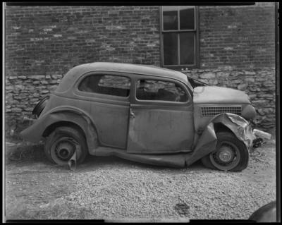 O.K. Service Garage (575 West Main); two wrecked (damaged) cars;                             photographs requested by John L. Davis; garage, exterior; wrecked                             (damaged) car, passenger's side view