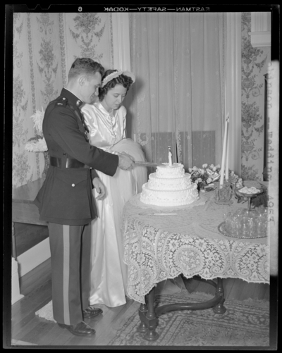 Robinson Wedding (two weddings); West Maple, Nicholasville);                             portrait book; bride and groom cutting wedding cake; groom dressed in a                             uniform