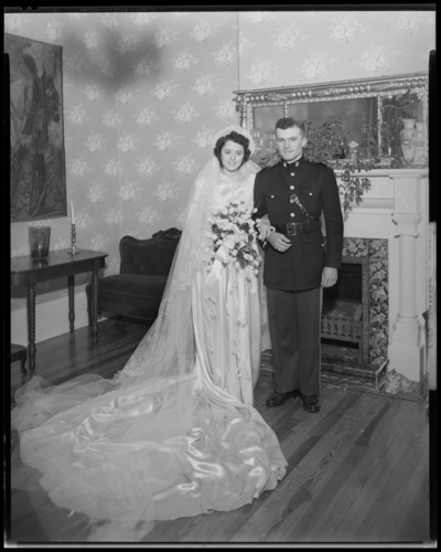 Robinson Wedding (two weddings); West Maple, Nicholasville);                             portrait book; bride and groom standing in front of a fireplace; groom                             dressed in a uniform