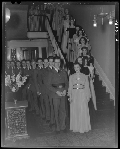 M.M.I. & Sayre College, 194 North Limestone; reception                             & glee club; group of women dressed in formal attire standing on                             a staircase; group of men standing in a line below the                             staircase