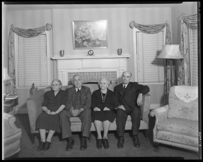 Frank J. Reeves & Family; interior, living room; group of                             four family members sitting on sofa