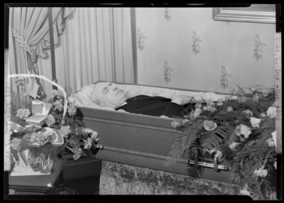 Chas. L. Day; corpse; open casket surrounded by                             flowers