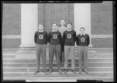 Georgetown College basketball team ; unknown individuals standing                             on steps of building