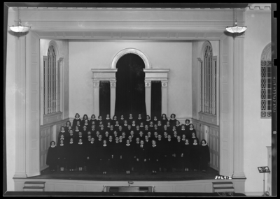 Combined Glee Club standing on stage of Memorial Hall; University                             of Kentucky
