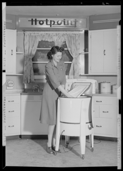 Kentucky Utilities Company (167 West Main Street); woman                             demonstrating ringer-type washing machine (Hotpoint)