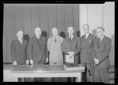 Kentucky Utilities Company (167 West Main Street); group of men                             standing around table