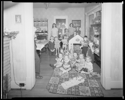 Mrs. E.J. Reynolds; childrens' Christmas party; children in                             house