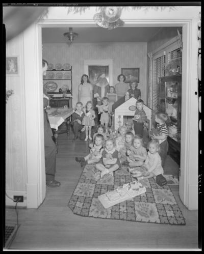Mrs. E.J. Reynolds; childrens' Christmas party; children in                             house