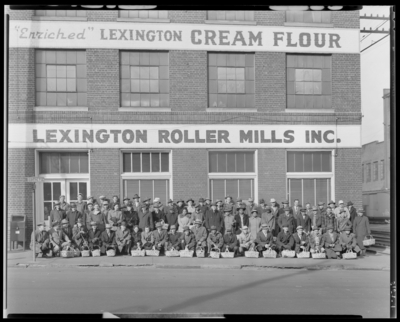 Lexington Roller Mills, 133 South Broadway; Christmas Party group                             standing at exterior of building