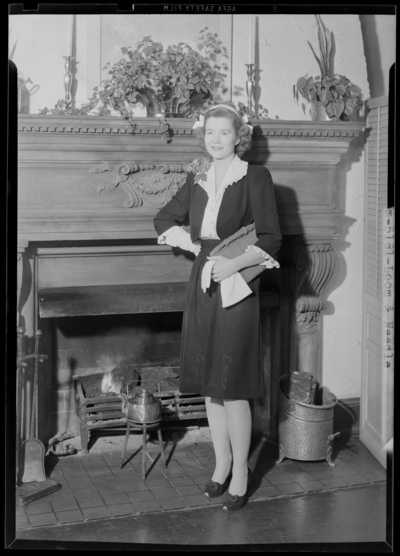 Loom & Needle, 170 Esplanade (clothing); woman standing                             next to fireplace