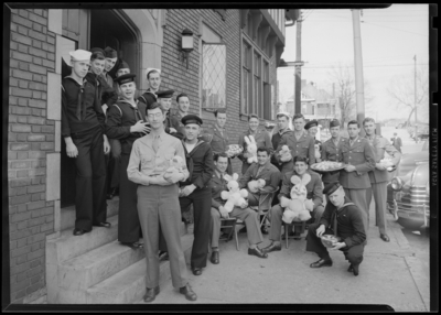 Stop-Over Station; military standing on steps with Easter bunnies                             and eggs