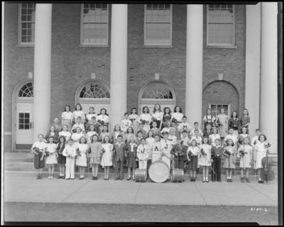 Elementary Band & Orchestra standing on steps of                             building