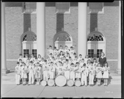 Elementary Band & Orchestra standing on steps of                             building