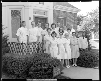Dr. J.B. Staton; staff standing at front exterior of                             building