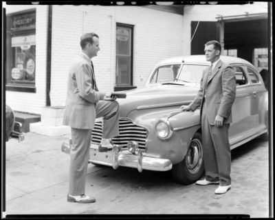 Lexington General Tire Company, 254 East Main; two men talking                             next to car
