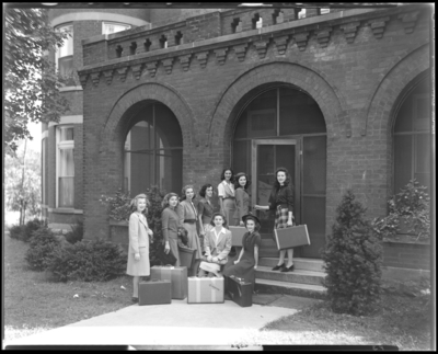 Georgetown College; building; exterior; group of women with                             suitcases